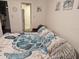 Bedroom with coordinated sea turtle bedding, chair, and a view into the ensuite bathroom at 3528 Lake Bayshore Dr # K-115, Bradenton, FL 34205