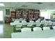 Spacious clubhouse room includes tables, chairs, a library, and comfortable space at 3528 Lake Bayshore Dr # K-115, Bradenton, FL 34205