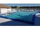 Inviting community pool area featuring blue-tiled pool, comfortable lounge chairs, and well maintained fencing at 3528 Lake Bayshore Dr # K-115, Bradenton, FL 34205