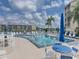 Refreshing community pool with sun loungers and umbrellas offers a relaxing resort-style experience for residents at 3528 Lake Bayshore Dr # K-115, Bradenton, FL 34205