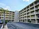 Exterior view of condo with a palm tree and parking available at 3528 Lake Bayshore Dr # K-115, Bradenton, FL 34205