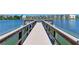 Picturesque dock extending over a lake, framed by waterfront apartments at 3528 Lake Bayshore Dr # K-115, Bradenton, FL 34205