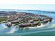 Aerial view of waterfront community with lush landscaping and boat docks at 3850 Mariners Walk # 713, Cortez, FL 34215