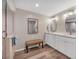 Modern bathroom featuring dual sinks, granite countertops, a glass enclosed shower, and wood plank flooring at 3850 Mariners Walk # 713, Cortez, FL 34215