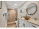 Bathroom with a vessel sink, stone countertops, framed mirror and tiled walk-in shower at 3850 Mariners Walk # 713, Cortez, FL 34215