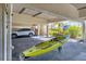 View of parking spot under building, with car and kayak at 3850 Mariners Walk # 713, Cortez, FL 34215