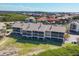 Rear exterior view of condo buildings with screened lanais overlooking the water at 3850 Mariners Walk # 713, Cortez, FL 34215