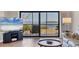 Living room featuring a large TV, hardwood floors, and sliding glass doors to the outdoor balcony at 3850 Mariners Walk # 713, Cortez, FL 34215