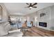 Bright living room with a stone fireplace, ceiling fan, and hardwood flooring at 3850 Mariners Walk # 713, Cortez, FL 34215