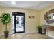 Bright, inviting lobby area enhanced by a decorative mirror, plant, and coastal decor at 3850 Mariners Walk # 713, Cortez, FL 34215