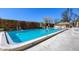 Community swimming pool surrounded by lush green hedges offering a private oasis at 3850 Mariners Walk # 713, Cortez, FL 34215