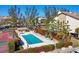 Aerial view of the community pool, pool house, and surrounding tropical landscape at 3850 Mariners Walk # 713, Cortez, FL 34215