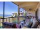 Outdoor seating on screened lanai with water view at 3850 Mariners Walk # 713, Cortez, FL 34215