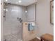 Beautiful shower featuring a glass enclosure, stone tile, and a rainfall shower head for a luxurious experience at 3850 Mariners Walk # 713, Cortez, FL 34215