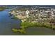 Aerial view of property on a lush coastline with mature trees and greenery overlooking tranquil waters at 400 Dona Dr, Nokomis, FL 34275