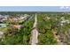 Aerial view of canal front homes with mature trees and greenery overlooking canal waters at 400 Dona Dr, Nokomis, FL 34275