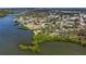 Aerial view of property on a lush coastline with mature trees and greenery overlooking tranquil waters at 400 Dona Dr, Nokomis, FL 34275