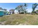 Large backyard featuring well-maintained lawn, with convenient access to the home's outdoor amenities at 400 Dona Dr, Nokomis, FL 34275