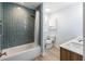 Bright bathroom features a tub/shower with blue subway tile, dual sink vanity, and shutters at 400 Dona Dr, Nokomis, FL 34275