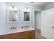 Bathroom featuring dual sink vanity with carrara top and blue tiled shower in background at 400 Dona Dr, Nokomis, FL 34275