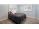 Cozy bedroom with two windows and wood-look tile flooring at 400 Dona Dr, Nokomis, FL 34275