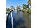 Scenic view of the tranquil canal waterway with boats docked at private piers in a lush, waterfront community at 400 Dona Dr, Nokomis, FL 34275