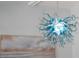 Blue glass chandelier hanging from the ceiling with a painting below it at 400 Dona Dr, Nokomis, FL 34275
