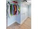 Walk-in closet with clothes hanging on clothing rack at 400 Dona Dr, Nokomis, FL 34275