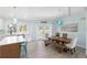 Dining room with modern table set, beautiful lighting, and light wood floors at 400 Dona Dr, Nokomis, FL 34275