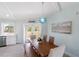 Bright dining room featuring a wooden table with seating for six and a unique chandelier at 400 Dona Dr, Nokomis, FL 34275