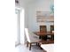 A light blue dining room featuring a wood table and an ornate light fixture at 400 Dona Dr, Nokomis, FL 34275