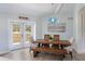 A light blue dining room featuring a wood table and an ornate light fixture at 400 Dona Dr, Nokomis, FL 34275