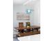 A light blue dining room featuring a wood table and an ornate light fixture at 400 Dona Dr, Nokomis, FL 34275