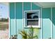 Close up of side of the home with window and tropical plants at 400 Dona Dr, Nokomis, FL 34275