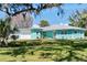 Beautiful single-Gathering home featuring a lush green lawn and charming curb appeal with a light blue exterior at 400 Dona Dr, Nokomis, FL 34275