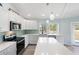 Bright kitchen featuring white quartz counters and stainless steel appliances at 400 Dona Dr, Nokomis, FL 34275