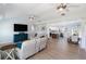 Spacious living room featuring wood look floors, ceiling fans, and lots of natural light at 400 Dona Dr, Nokomis, FL 34275