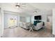 Bright living room with wood floors, a ceiling fan, and lots of windows at 400 Dona Dr, Nokomis, FL 34275