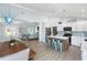 Open concept living space with a kitchen, dining area, and living room, creating an inviting atmosphere at 400 Dona Dr, Nokomis, FL 34275