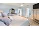 Spacious main bedroom featuring wood floors, ceiling fan, television and en suite bathroom at 400 Dona Dr, Nokomis, FL 34275