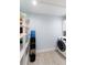 Pantry room with open shelving, a Primo water dispenser, and a washer dryer at 400 Dona Dr, Nokomis, FL 34275
