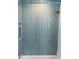 Bathtub shower with blue subway tile surround and niche at 400 Dona Dr, Nokomis, FL 34275