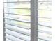 Close up view of a window with plantation shutters in the closed position at 400 Dona Dr, Nokomis, FL 34275