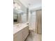 Bathroom with white cabinet, large mirror, soaking tub, and light green walls at 4114 63Rd E Ter, Sarasota, FL 34243