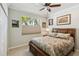 Bedroom with ceiling fan, carpet and wood furniture at 4114 63Rd E Ter, Sarasota, FL 34243