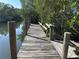 Private wooden dock surrounded by water and mangrove trees on a clear, sunny day at 4207 Marina View Way, Cortez, FL 34215