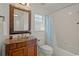Bathroom with a bronze faucet and sink, and a bathtub and shower combination with tile surround at 4410 Murfield E Dr, Bradenton, FL 34203
