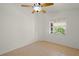 Well-lit bedroom featuring a ceiling fan and tiled flooring at 4410 Murfield E Dr, Bradenton, FL 34203