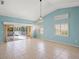 Open-concept living area with vaulted ceilings, tile floors, natural light, and access to the screened pool area at 4410 Murfield E Dr, Bradenton, FL 34203