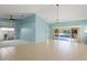 Spacious living room with tile flooring, sliding glass doors to the pool, and contemporary lighting at 4410 Murfield E Dr, Bradenton, FL 34203